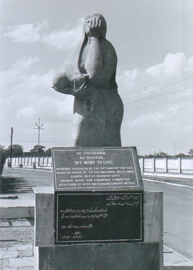 The Bhopal disaster memorial statue by Ruth Waterman — a mother shielding her children as she flees — standing near the former Union Carbide factory.